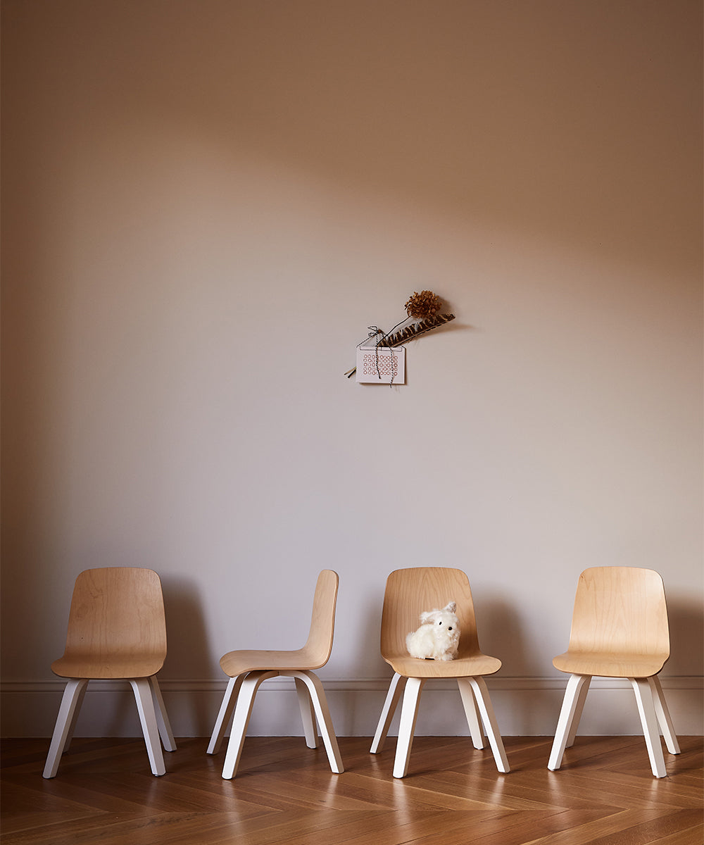 Two sets of Play Chairs, totaling four in all, are arranged against a wall with a small stuffed toy and decorative piece above.