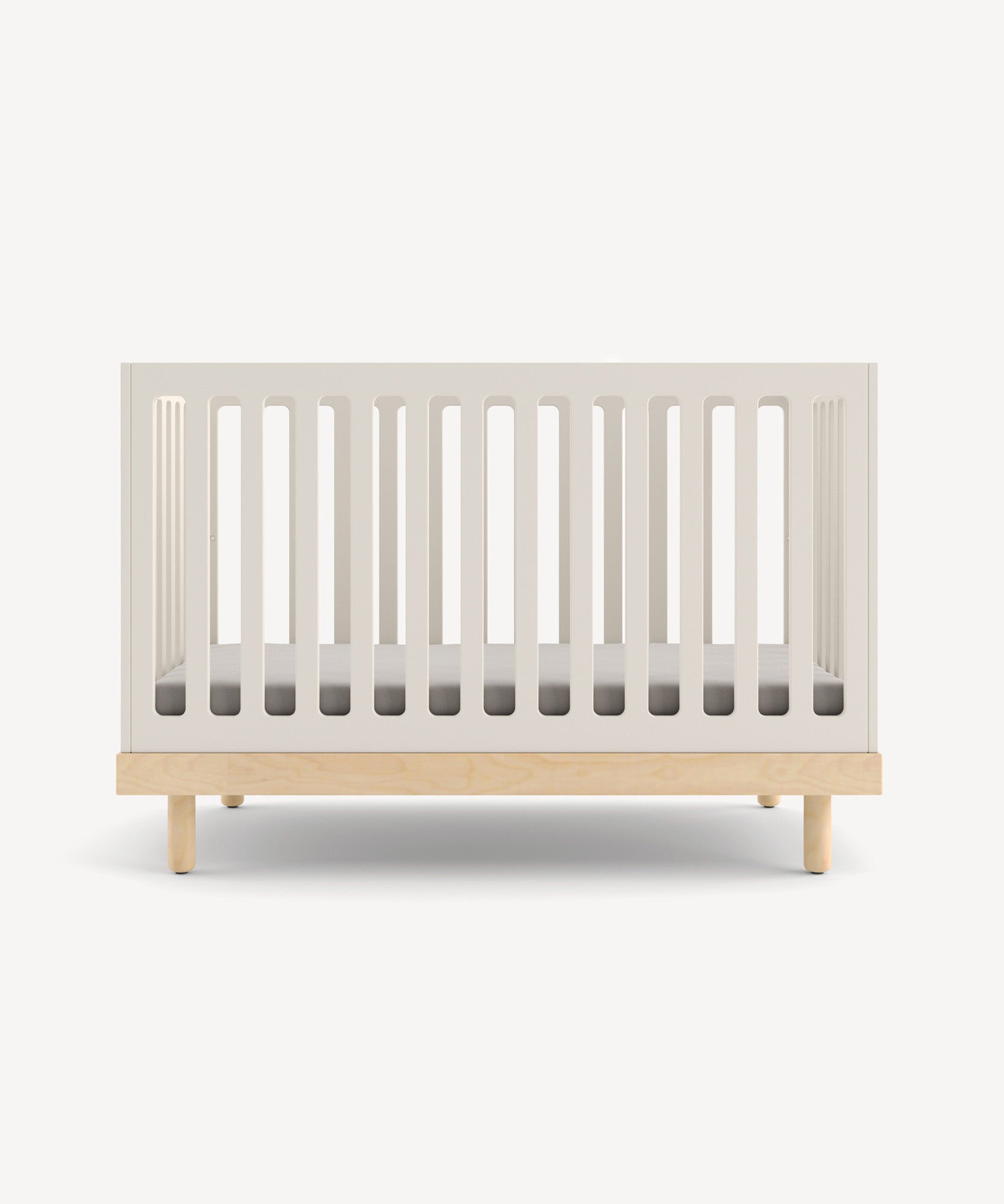 The Classic Crib features a minimalist wooden design with white slatted sides and a simple mattress, set against a plain background.