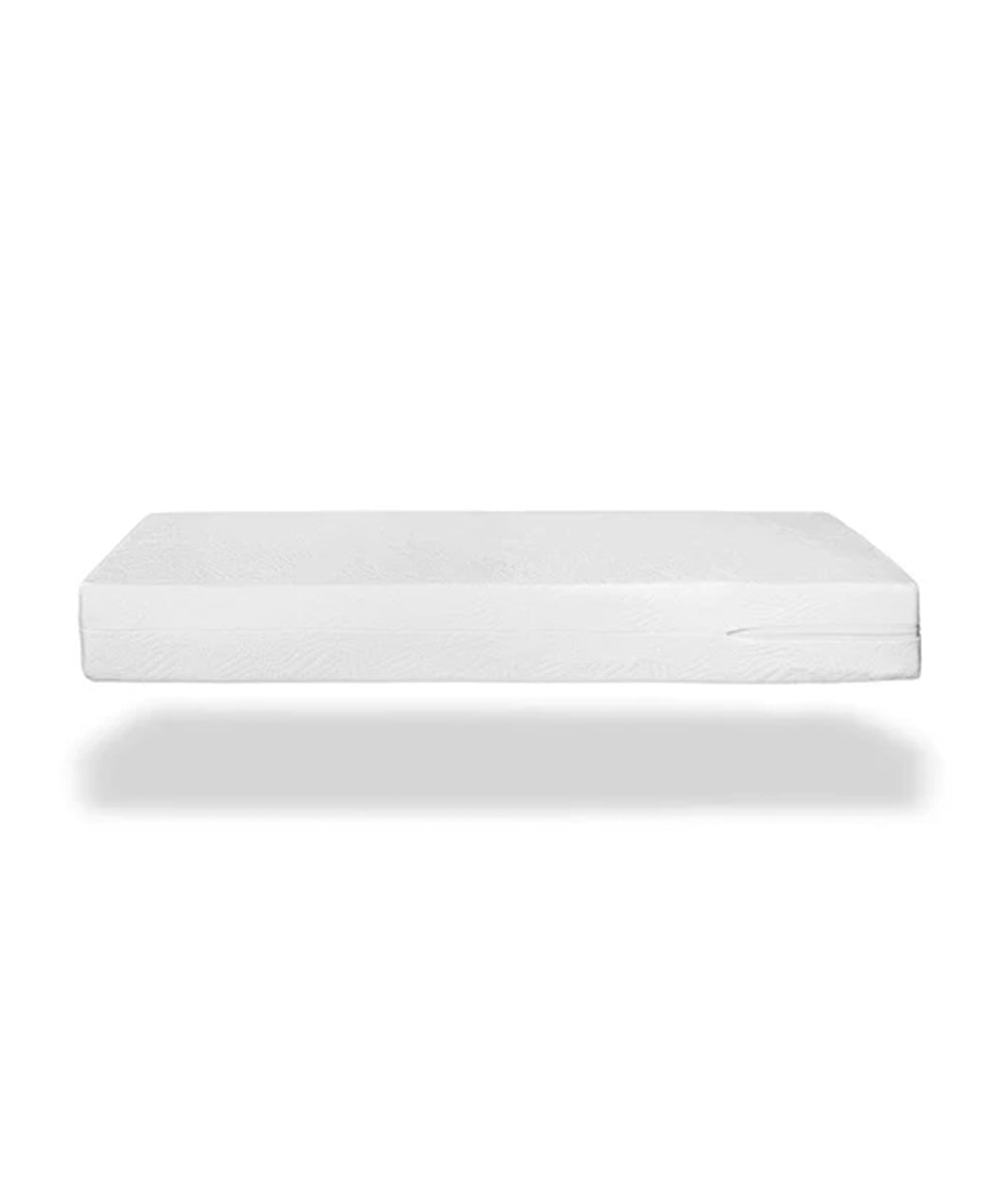 The Dual Firm Crib Mattress, made from organic cotton for a gentle touch, floats seamlessly on a plain white background as an eco-friendly, white crib mattress.