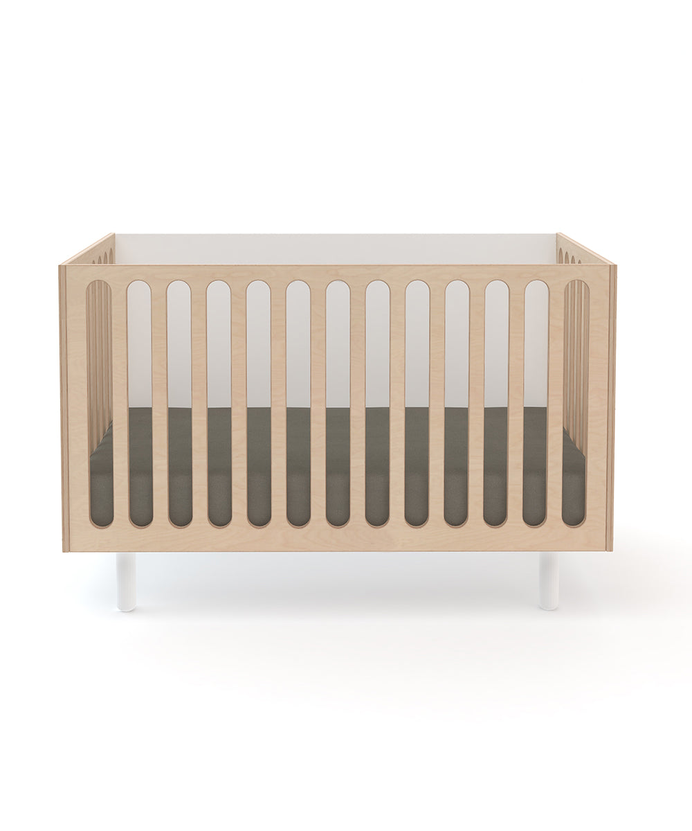 The Fawn 2-in-1 Crib System features vertical slats and a dark mattress, displayed against a white background.