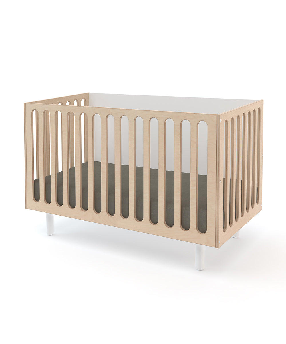 The Fawn 2-in-1 Crib System is a modern wooden baby crib featuring vertical slats and white legs, shown against a white background.