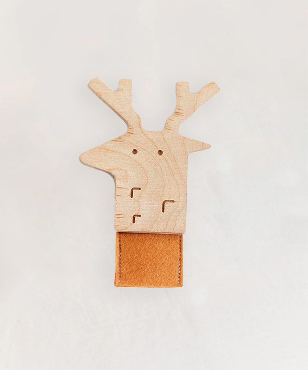 Le Deer Finger Puppet featuring a wooden reindeer head with antlers, mounted on a rectangular brown leather piece against a light background.