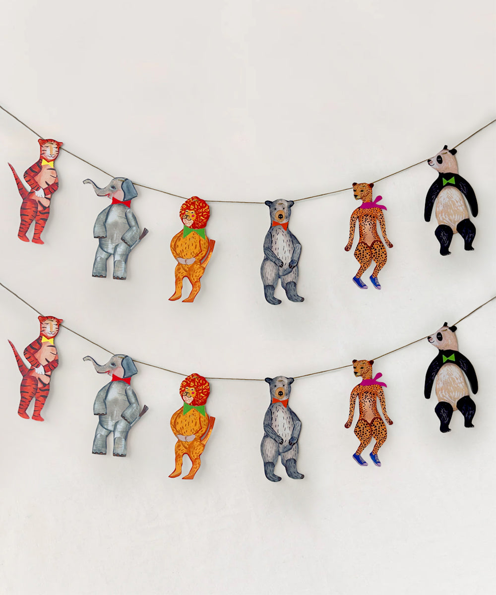 Le Garland - Animal Parade features a string garland with cutouts of cartoon animals, including elephants, bears, cheetahs, pandas, tigers, and a lion head, arranged in two rows.