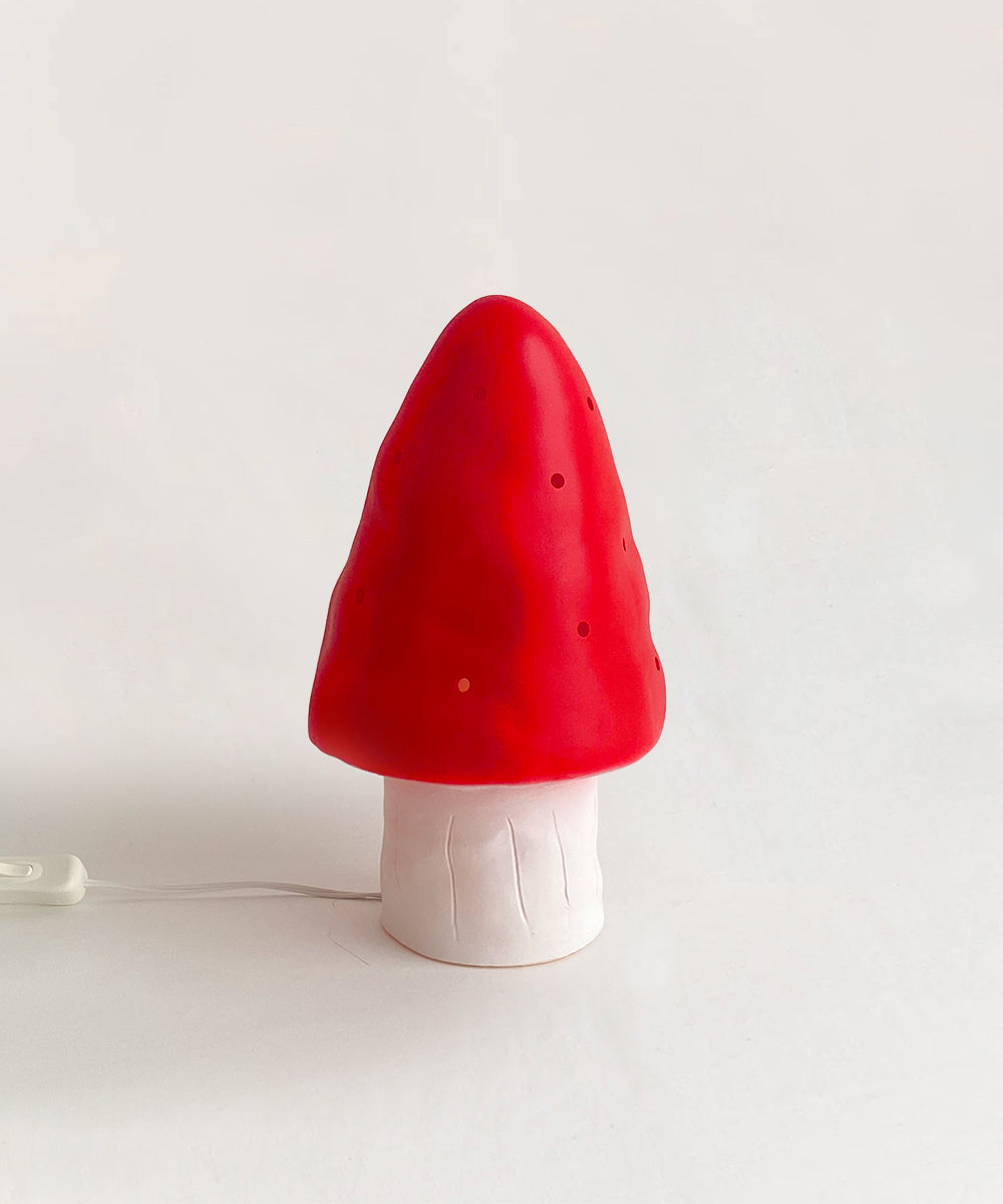 Le Small Mushroom Lamp in red and white on a plain background.