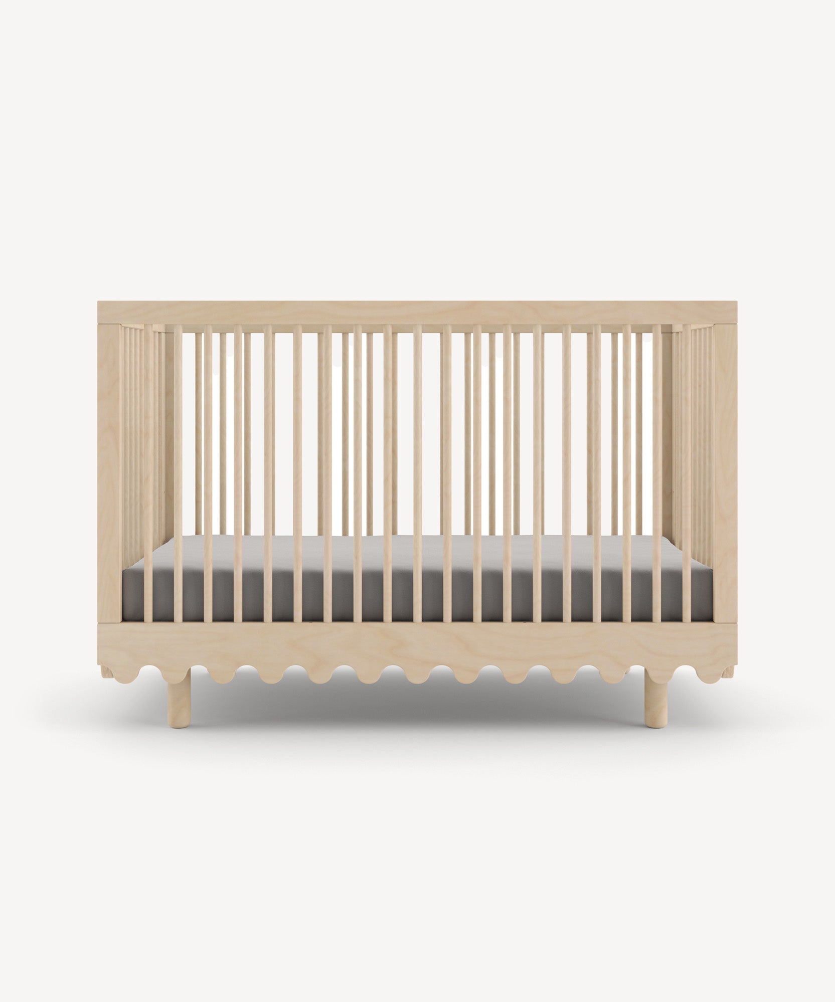 Moss Crib: A natural wood baby crib with slatted sides, a wavy base design, and a gray mattress included.