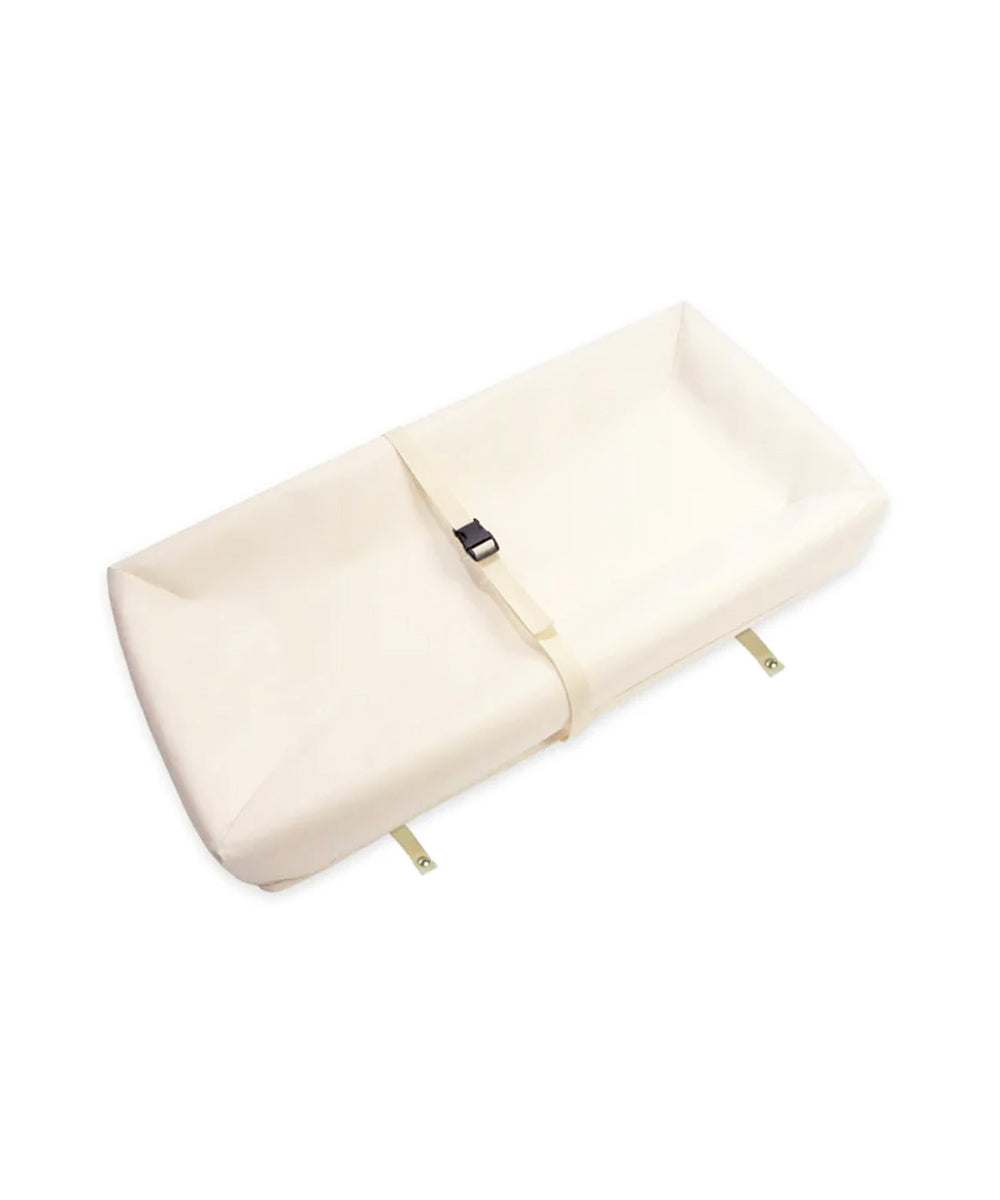 Naturepedic 4-Sided Changing Pad in beige with raised edges and safety strap, shown on a white background.