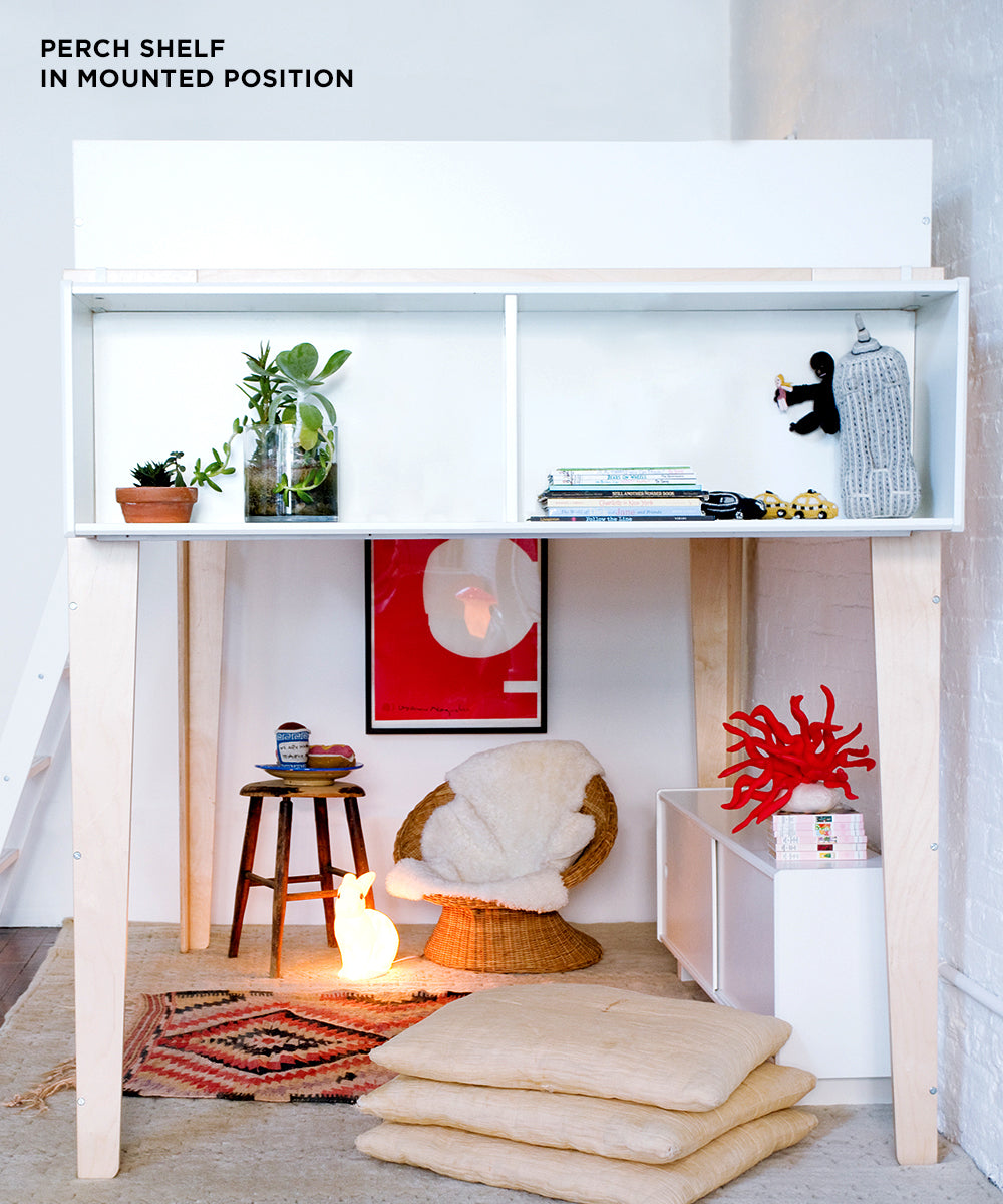 The Perch Shelf - Full Size features a loft bed with space above for plants, books, and toys, while below provides a cozy sitting area complete with cushions and a warm light.