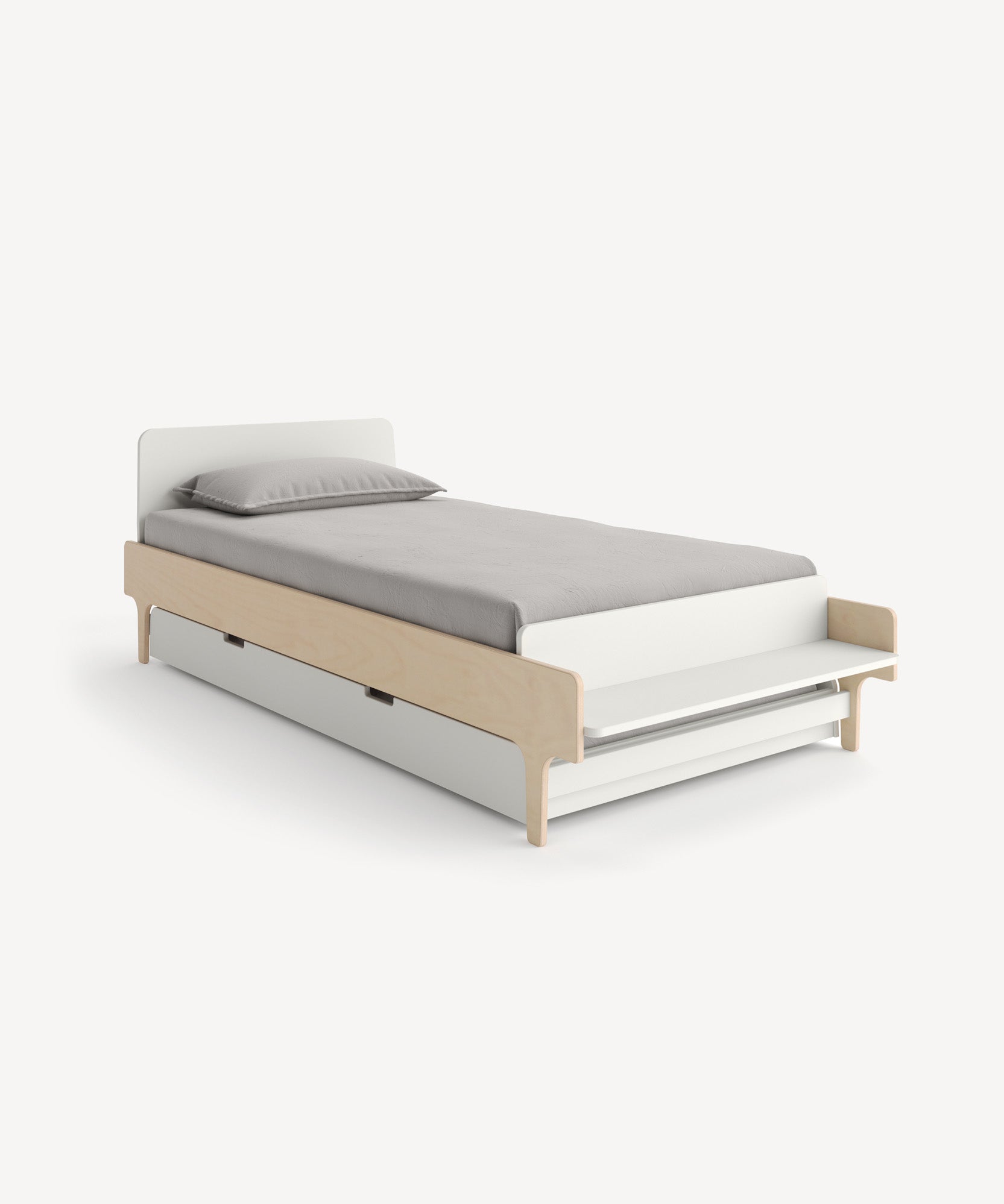 The River Trundle Bed is a minimalist single bed with a light wood frame, gray bedding, and an underneath pull-out trundle.