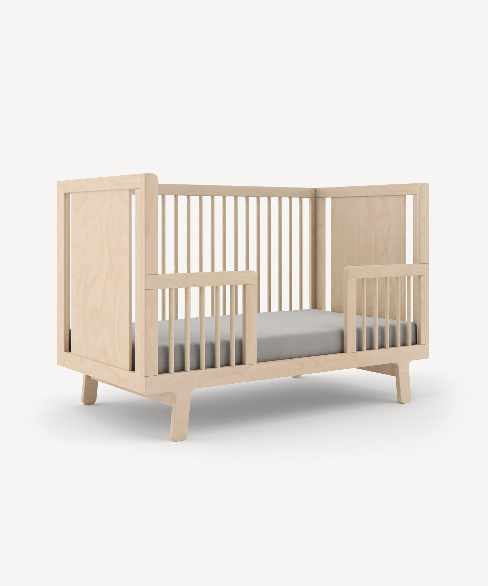 The Sparrow Toddler Bed Conversion Kit offers slatted sides and back with a minimalist modern design.