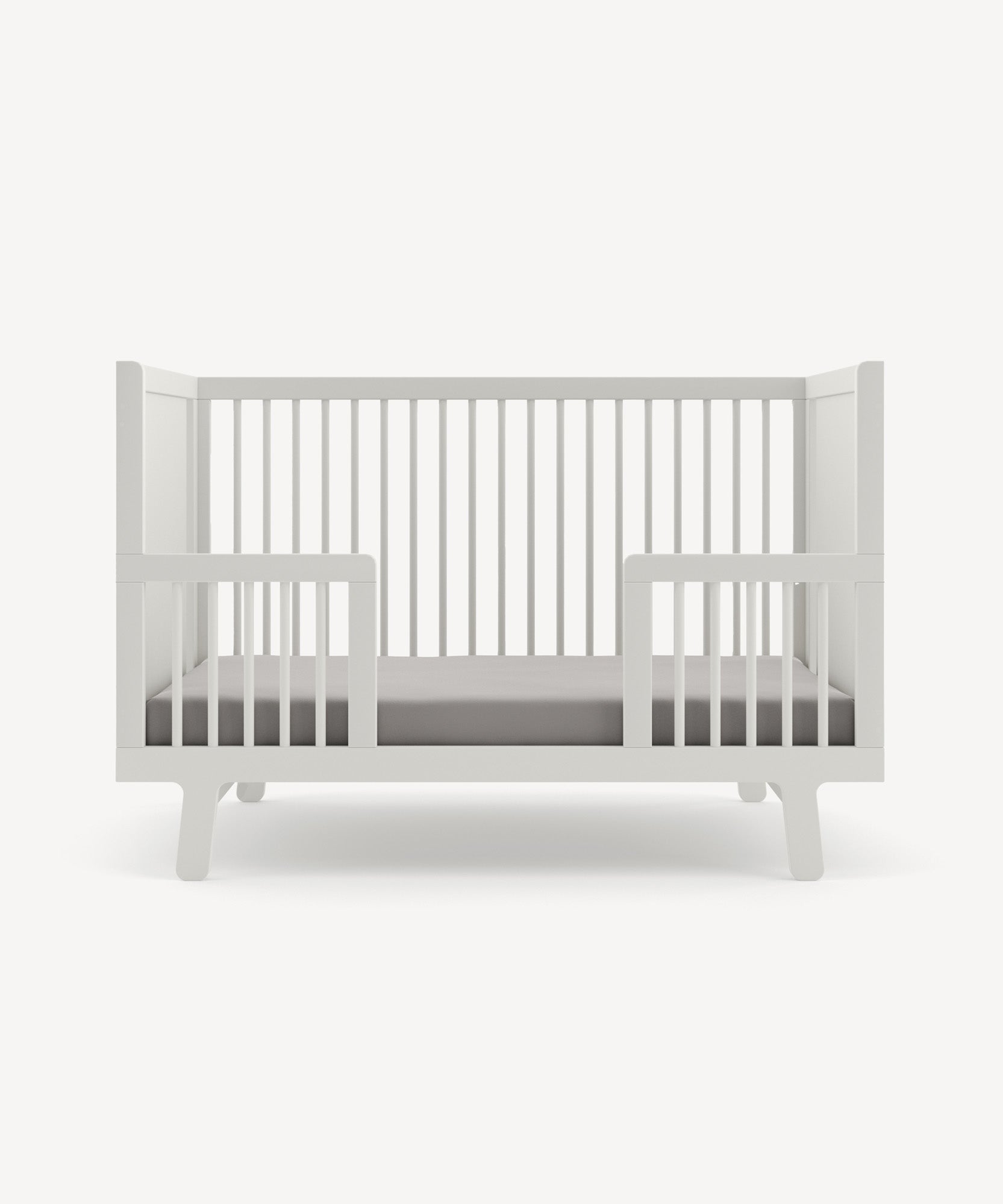 A Sparrow Toddler Bed Conversion Kit with slatted sides and a gray mattress, set against a plain light background.