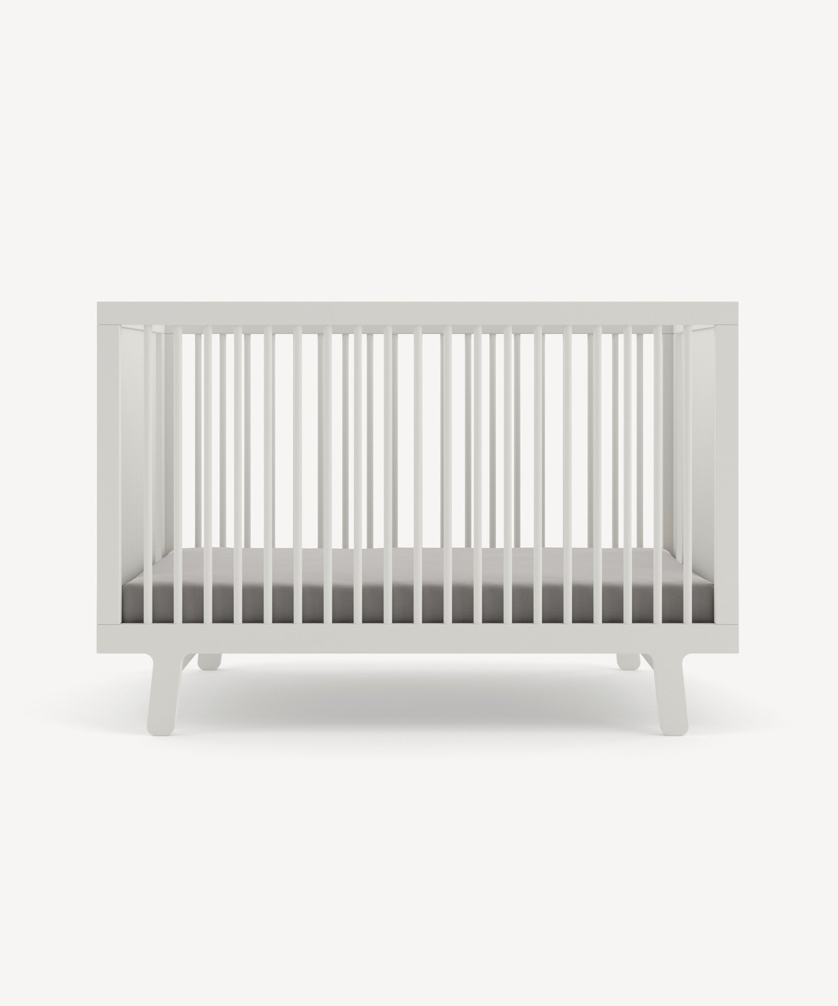 Sparrow Crib with slatted sides and a gray mattress on a plain white background.