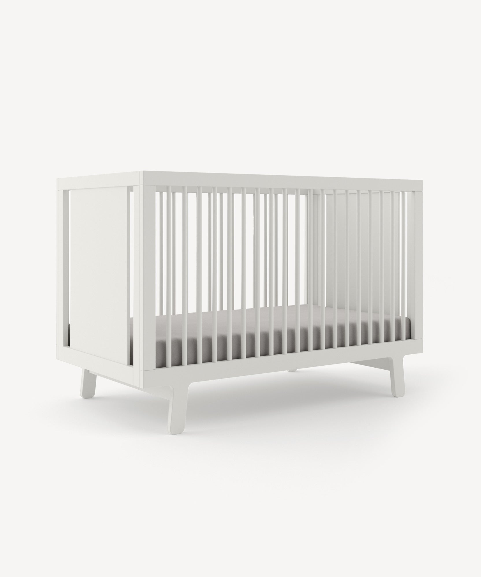 Modern Sparrow Crib in white with slatted sides and a minimalist design, set against a plain background.