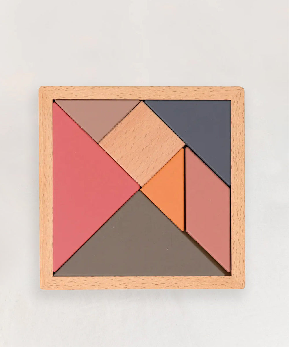 Le Tangram is a wooden puzzle featuring seven colorful geometric pieces arranged in a square frame.