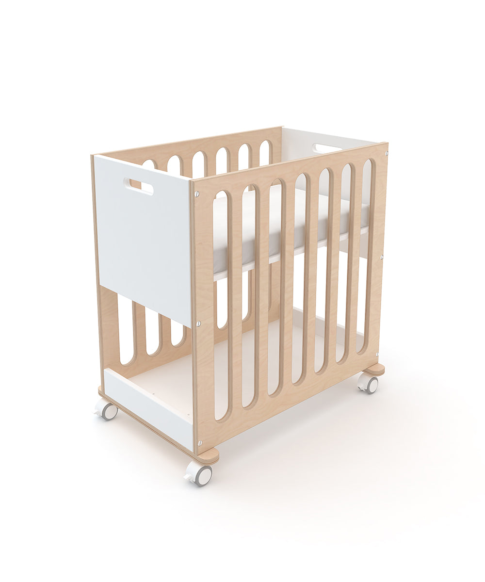 A Fawn 2-in-1 Crib System featuring wooden construction, white side panels, and wheels.