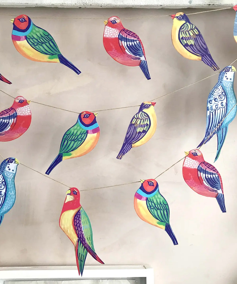 The Le Garland - Colorful Birds consists of vibrant paper bird cutouts strung together for wall decoration.