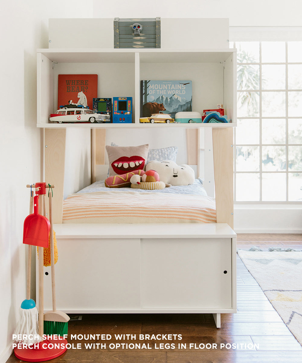 Kids room featuring a Perch Console - Twin Size lofted bed, toys, books, and a white shelf with a bright window in the background.