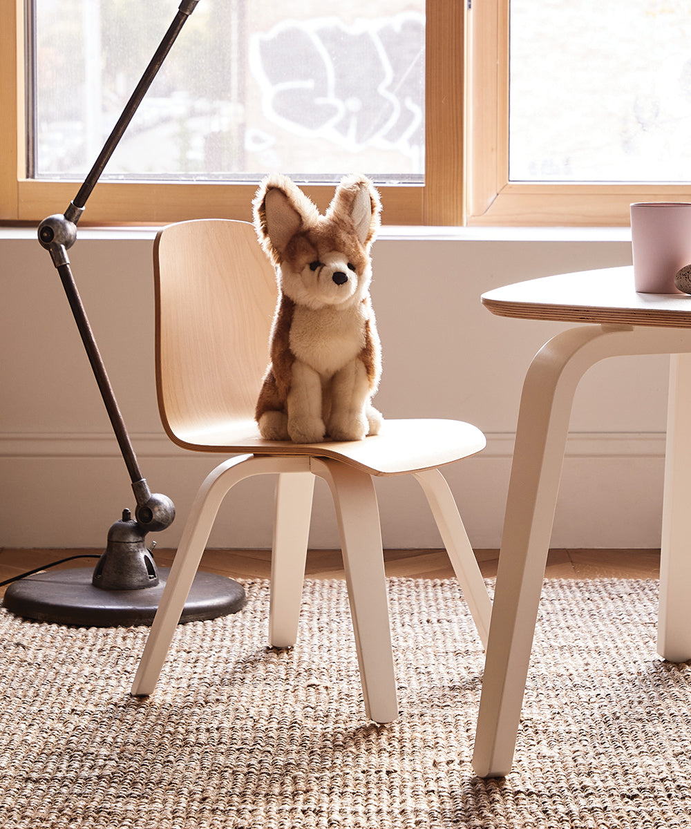 A stuffed fox toy rests on one of the Play Chairs (Set of 2) in a sunlit room with a floor lamp and table.