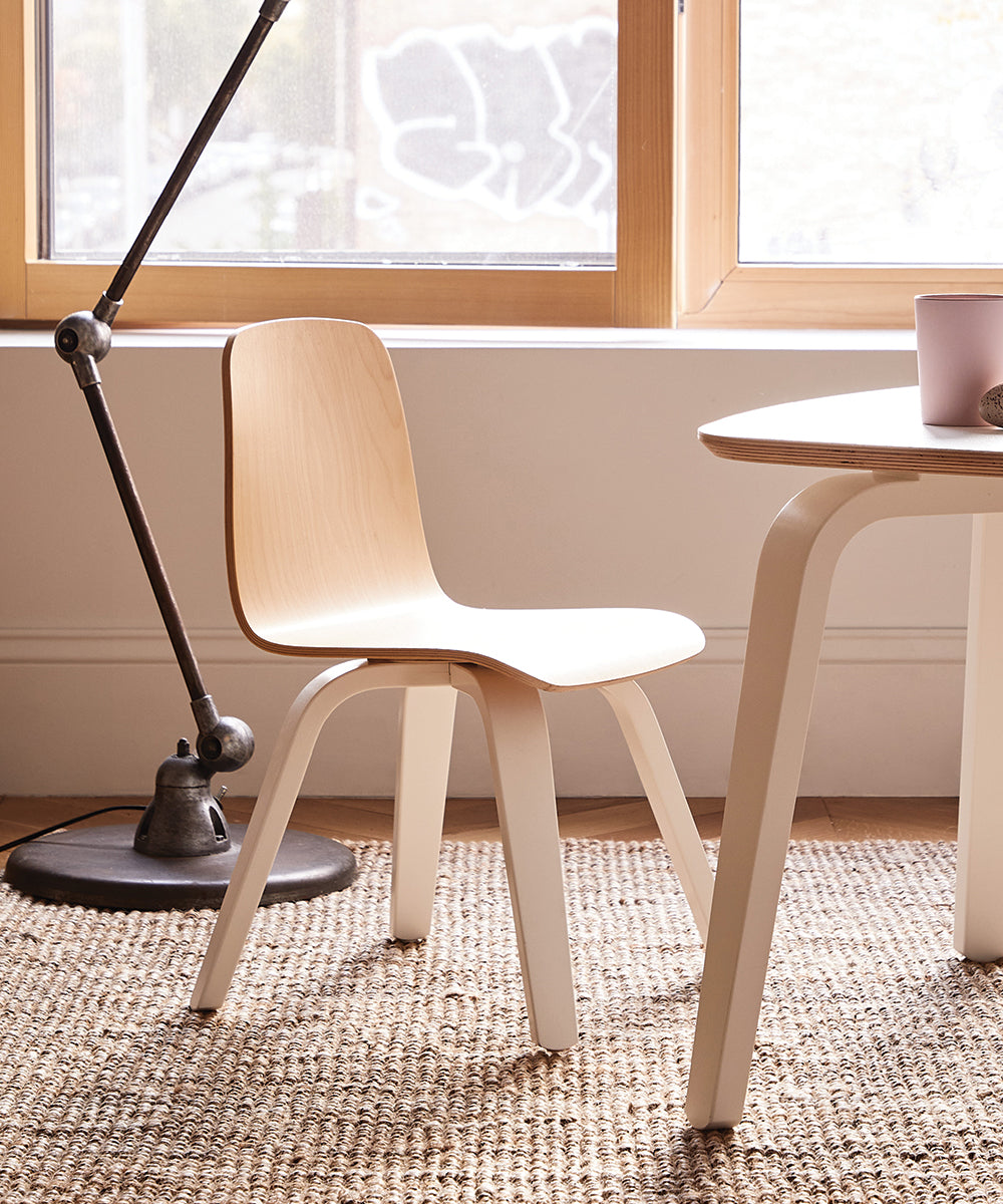 Play Chairs (Set of 2) on a woven rug near a large window with a floor lamp in the background.