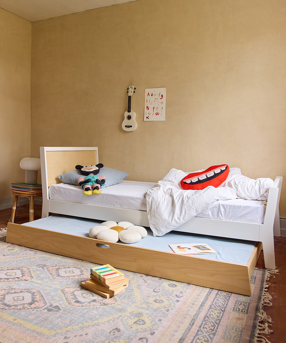 A cozy childrens room features the Sparrow Twin Bed, a guitar on the wall, playful cushions, and a colorful rug.