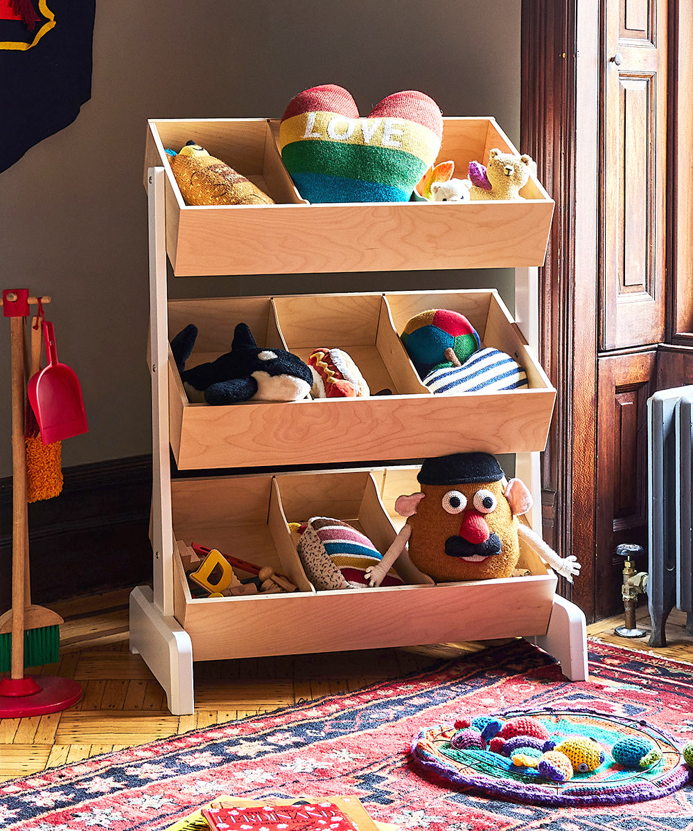 The Toy Store features a wooden toy organizer filled with colorful plush toys and topped with a LOVE heart, placed near a window and rug.