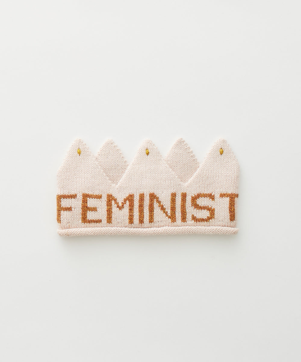 A "Feminist Crown" features a knitted design with "FEMINIST" boldly displayed on a white background.