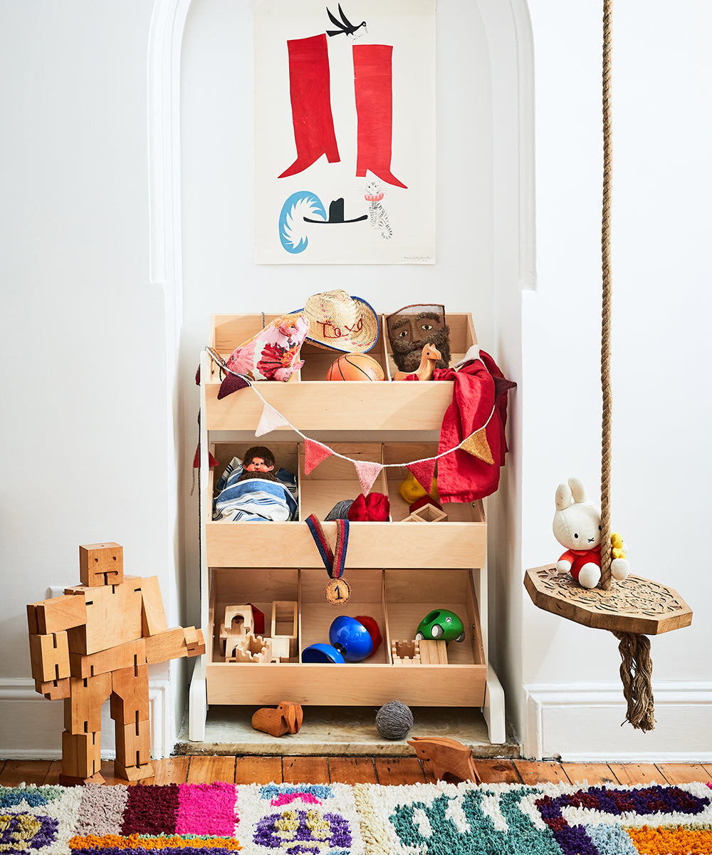 A Toy Store filled with various toys, a rope swing, and a colorful rug in a playful childrens room.